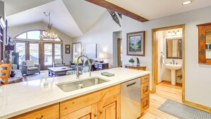 A spacious kitchen with a large island, wooden cabinets, and a built-in dishwasher. - Seasons Lodge at Arrowhead: Beaver Creek Condo! (Edwards)