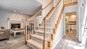 A staircase with wooden railings and carpeted steps leading to an upper floor. - Beulah Family Home ~ 2 Mi to Dtwn + Beach! (Beulah)