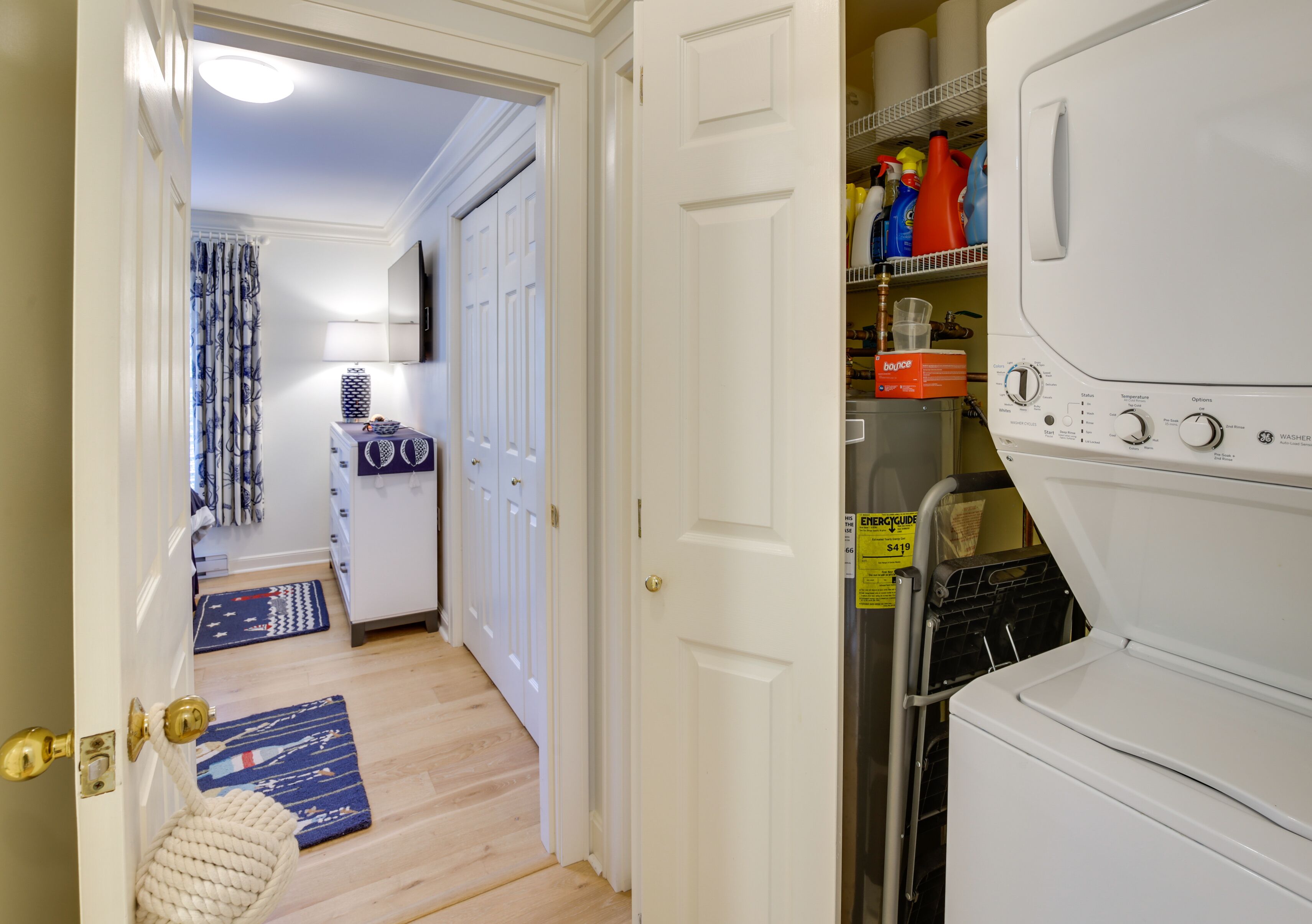 A laundry room with a washing machine, detergent, and a dryer.