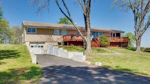 A two-story house with a front deck and a garage. - The View - Waterfront Lake Anna Home w/ Dock! (Bumpass)