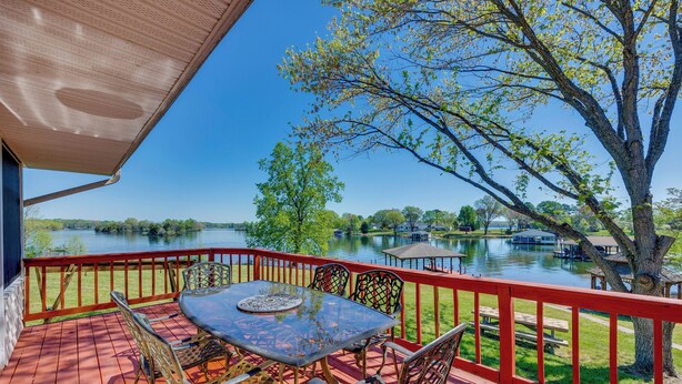 A deck with a table and chairs overlooking a lake. - The View - Waterfront Lake Anna Home w/ Dock! (Bumpass)