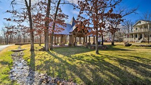 A gazebo with a pointed roof, surrounded by trees and a grassy area. - Cozy Carlton Landing Home - Near Lake Eufaula (Eufaula)
