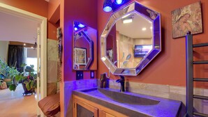 A bathroom with a wooden vanity, a large mirror, and a sink. - Cozy Emeryville Studio, Near Beaches & Parks! (Emeryville)