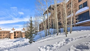 A snowy landscape with a building featuring multiple windows and a sloped roof. - Cozy Brian Head Condo Near Hiking & Biking! (Brian Head)