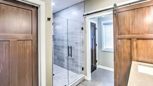 A modern interior with a sliding glass door, a wooden door, and a sliding barn door. - Chic Plymouth Townhome < 1 Mi to Road America (Plymouth)