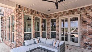 A covered patio with a sectional sofa, a coffee table, and a ceiling fan. - Chic Ranch Villa < 5 Mi to Lake Ray Roberts! (Pilot Point)