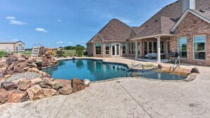 A residential property with a swimming pool, a covered patio, and a brick house. - Chic Ranch Villa < 5 Mi to Lake Ray Roberts! (Pilot Point)