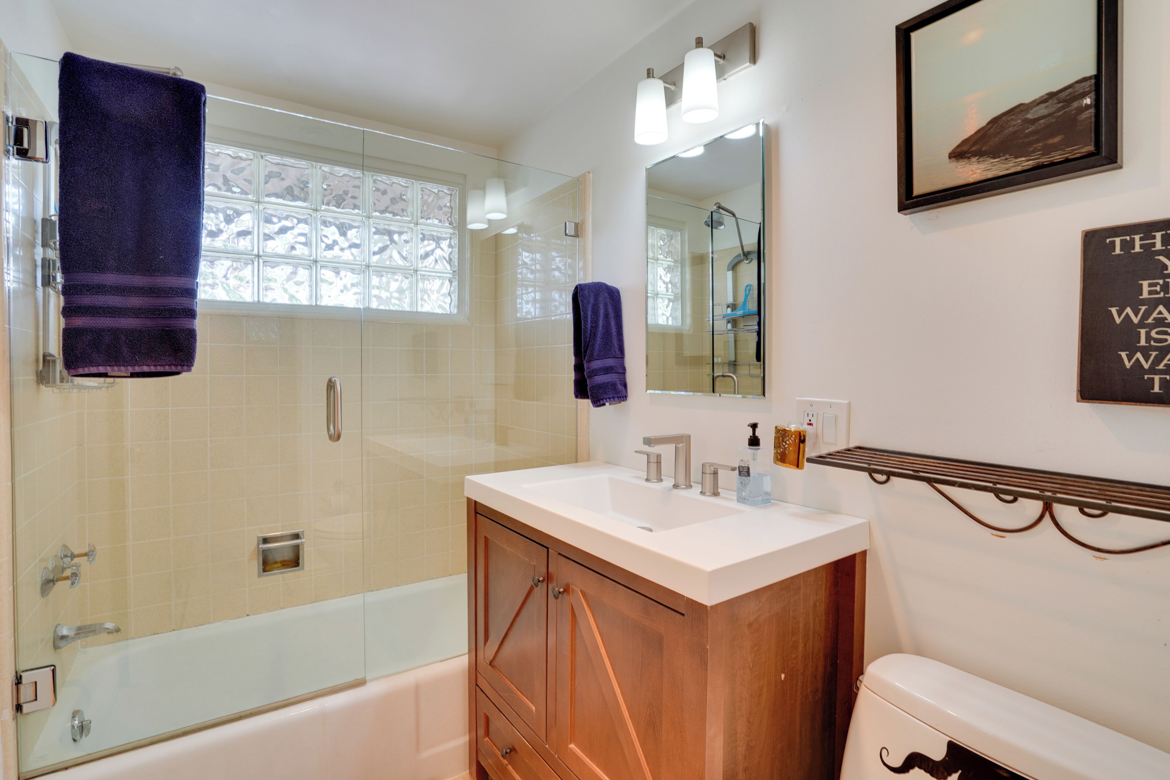 A bathroom with a bathtub, a shower, a sink, and a toilet.