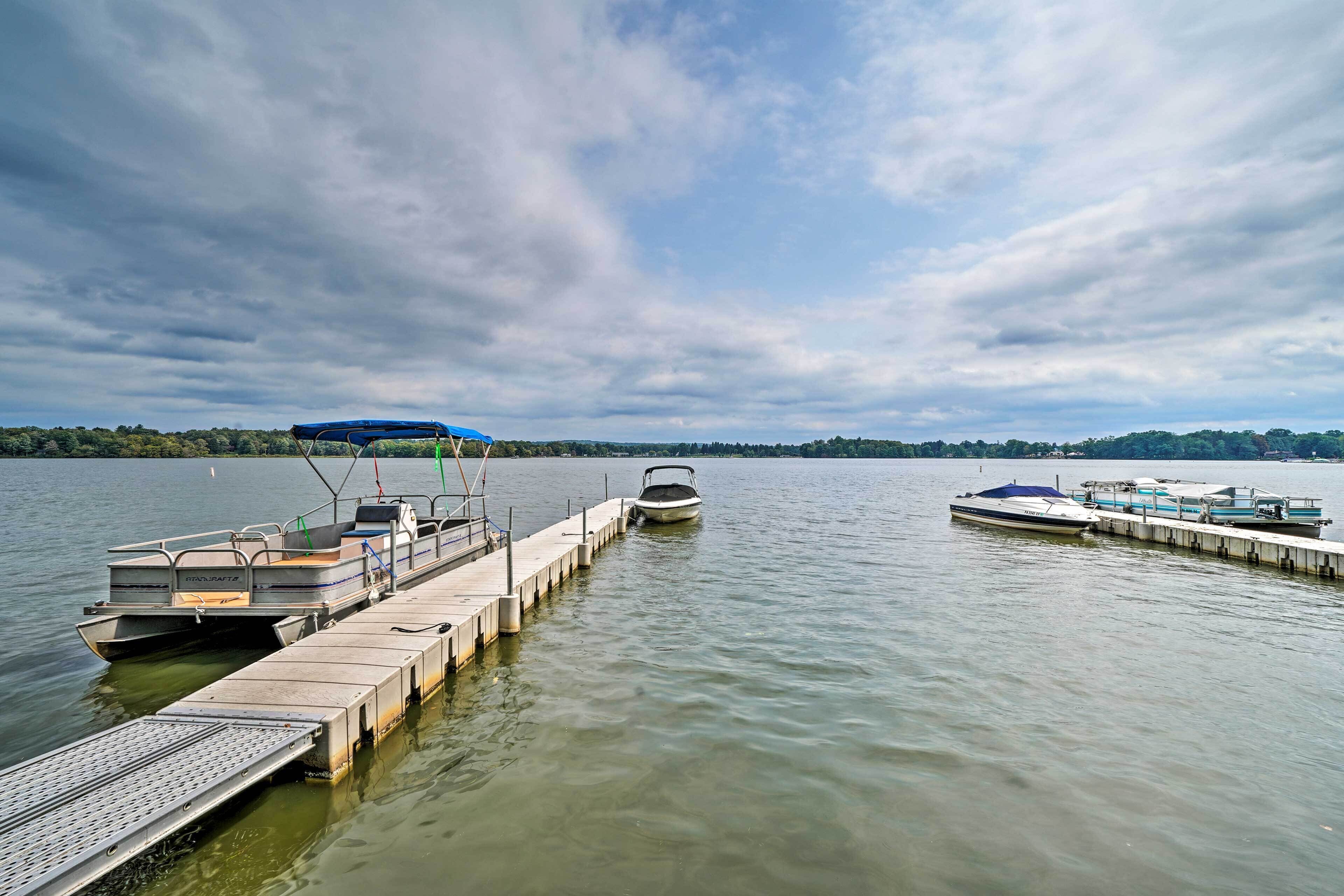 A dock with boats and a pier extending into calm water.