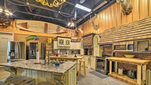 A spacious kitchen with a large island, wooden accents, and modern appliances. - Family Leatherwood Resort Cabin w/ Fire Pit! (Dover)