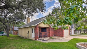 A single-story house with a brick exterior, a front porch with two chairs, and a small garden area. - Family Retreat ~ 1 Mi to Hill Country Mile! (Boerne)