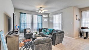 A living room with a sofa set, a television, and a ceiling fan. - La Porte Getaway w/ Deck: Steps to Beach! (La Porte)