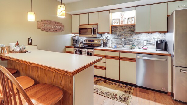 A kitchen with wooden cabinets, a stainless steel refrigerator, a microwave, and a coffee maker. - Walk to Dining! Townhome 1 Mi to Big Boulder Mtn (Lake Harmony)