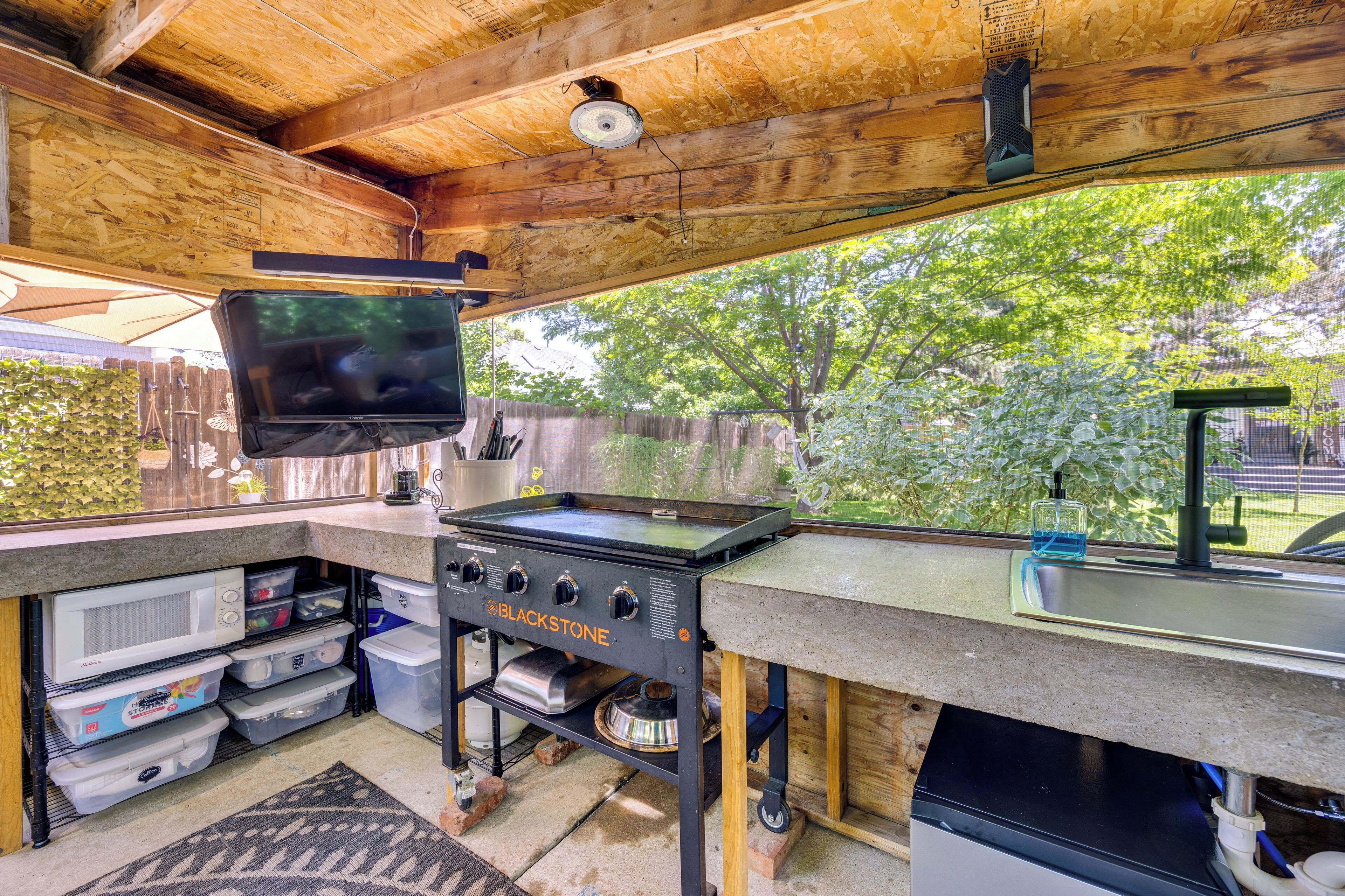 A kitchen with a built-in stove, microwave, and storage drawers.