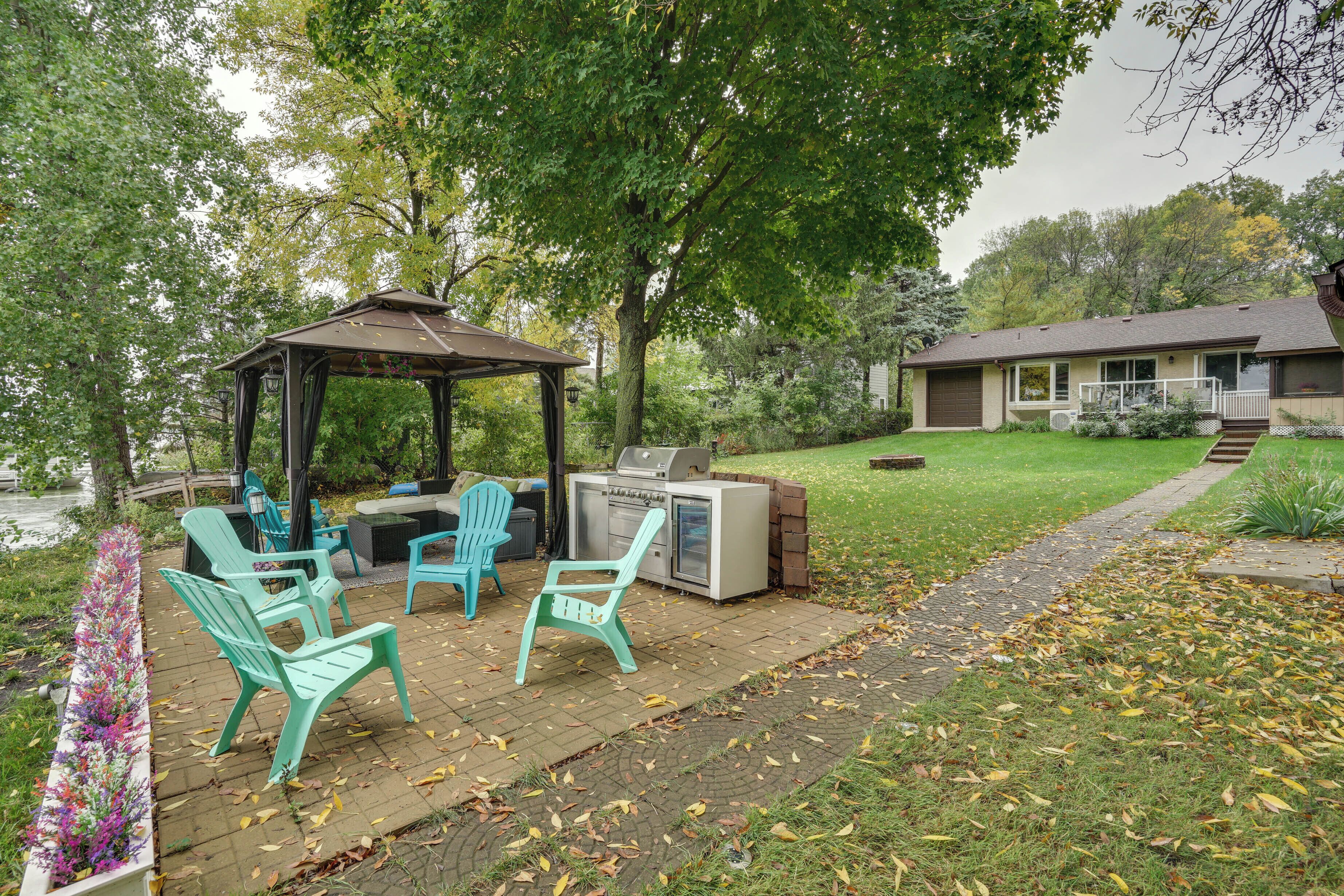 A patio with outdoor furniture, a grill, and a gazebo.