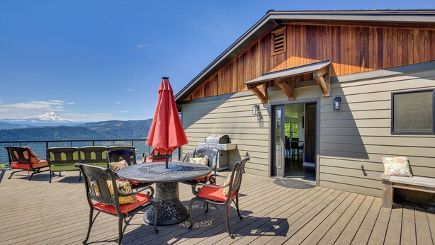 A deck with a table and chairs, a grill, and a view of mountains. - Mt Hood Views: Modern Underwood Home w/ Deck! (Underwood)