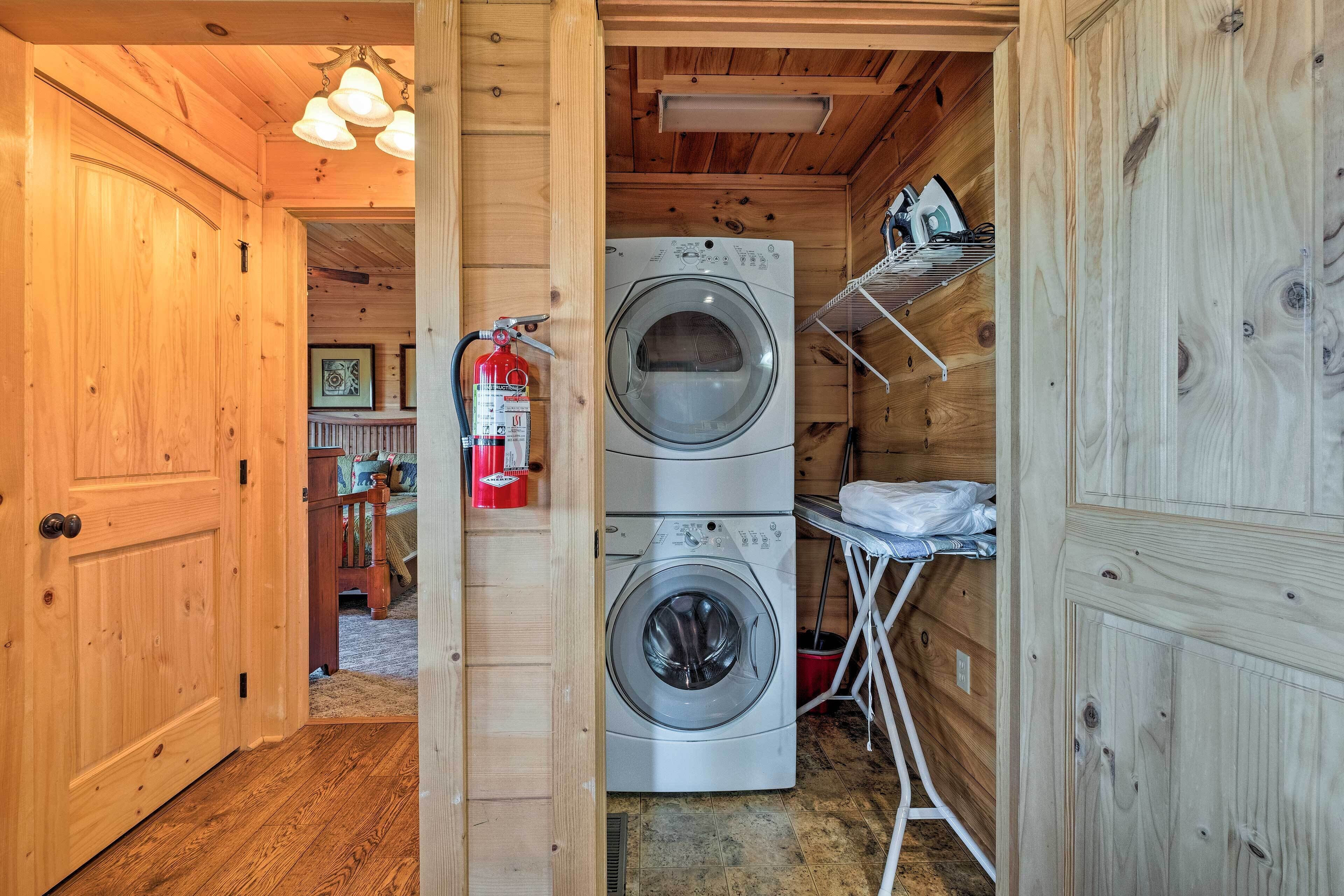 A wooden interior with a washing machine and a fire extinguisher.