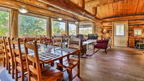 A wooden cabin interior with a dining area, living room, and kitchen. - < 1 Mi to Lake Granby: Log Cabin w/ Fire Pit (Grand Lake)