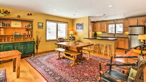 A spacious kitchen with wooden cabinets, a large island, and a dining area with a bench. - Mountaintop Ellicottville Home: 7 Mi to Ski Resort (Ellicottville)