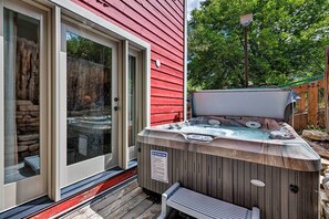 A hot tub outside a red building with a wooden deck and a bench. - Quiet Park City Home w/ Hot Tub - Walk to Main St! (Park City)
