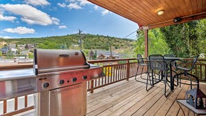 A wooden deck with a grill, outdoor seating, and a view of a hillside. - Quiet Park City Home w/ Hot Tub - Walk to Main St! (Park City)