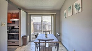A kitchen with an oven, cabinets, and a dining table with chairs. - San Antonio Abode w/ Yard: 17 Mi to Downtown! (San Antonio)