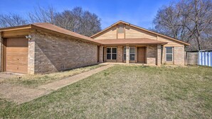 A single-story house with a brick exterior, a garage, and a front yard. - San Antonio Abode w/ Yard: 17 Mi to Downtown! (San Antonio)