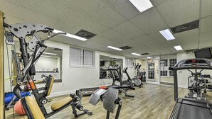 A gym with various exercise equipment, including treadmills and weight machines. - Resort-style Condo/suite on Golf Course w/ Pool! (Spring Lake)