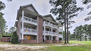 A multi-story building with a brick facade and white balconies. - Resort-style Condo/suite on Golf Course w/ Pool! (Spring Lake)