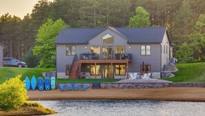 A large house with a balcony, a pool, and several blue chairs. - Lakefront Luxury - 1 MI to Buckhorn Boat Landing (New Lisbon)