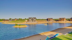 A lakeside residential area with houses, a wooden deck, and a swimming area. - Lakefront Luxury - 1 MI to Buckhorn Boat Landing (New Lisbon)