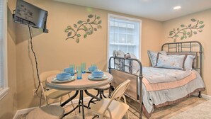 A bedroom with a bed, a small round table with chairs, a TV mounted on the wall, and decorative wall art. - Studio 1 Mi to Dtwn Hot Springs & Nat'l Park! (Hot Springs)