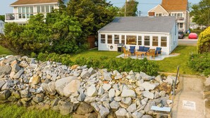 A house with a patio, a stone wall, and a sign that says "No Trespassing." - Waterfront Cottage w/ Sunroom + Patio & Grill (Clinton)