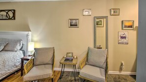 A hotel room with a bed, two armchairs, a small table, and a mirror. - Wintergreen Resort Studio w/ Deck & Ski-out Access (Nellysford)