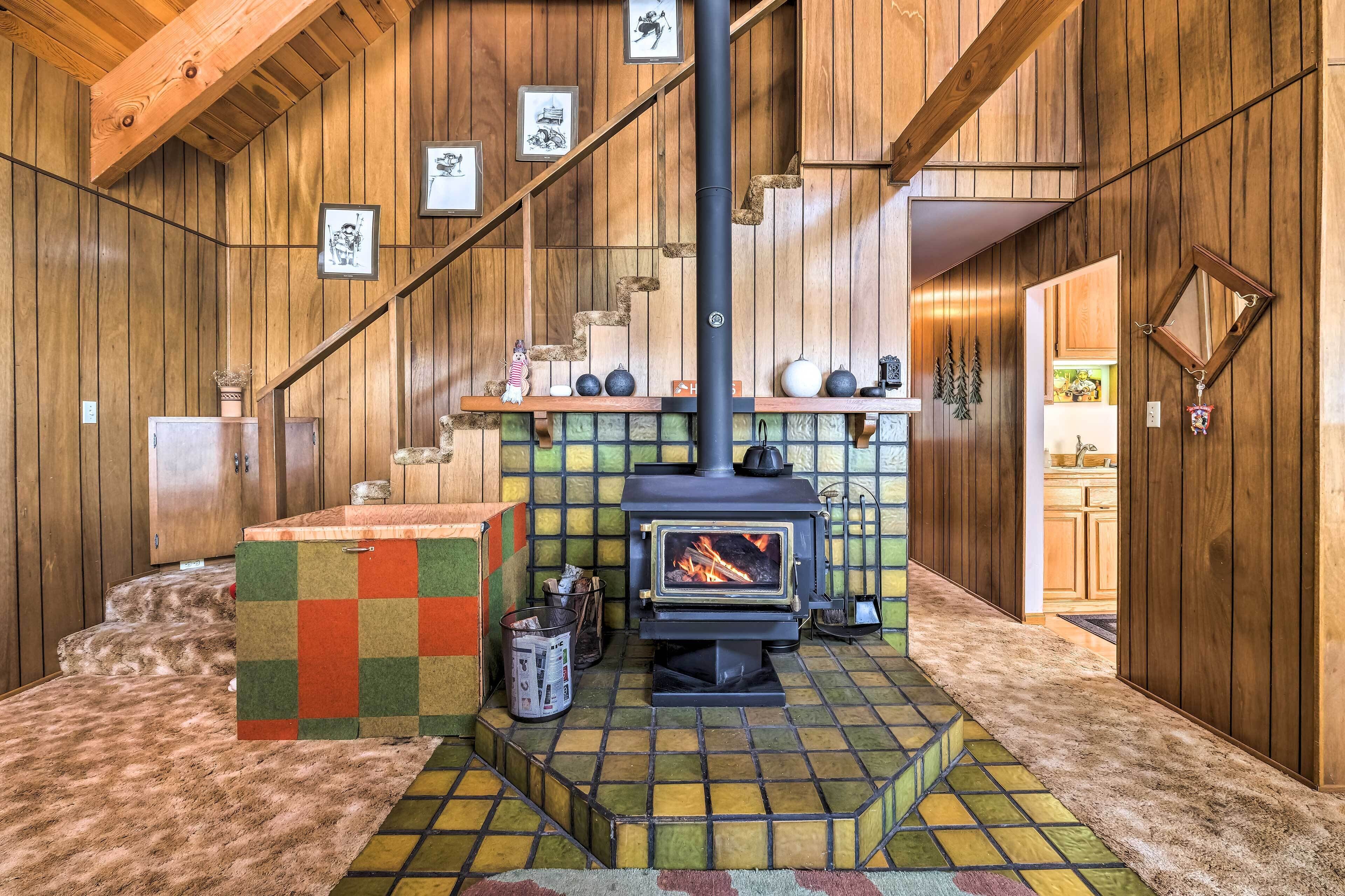Ein gemütliches Zimmer mit Holzvertäfelung, Kamin und Schachbrettmuster-Boden.