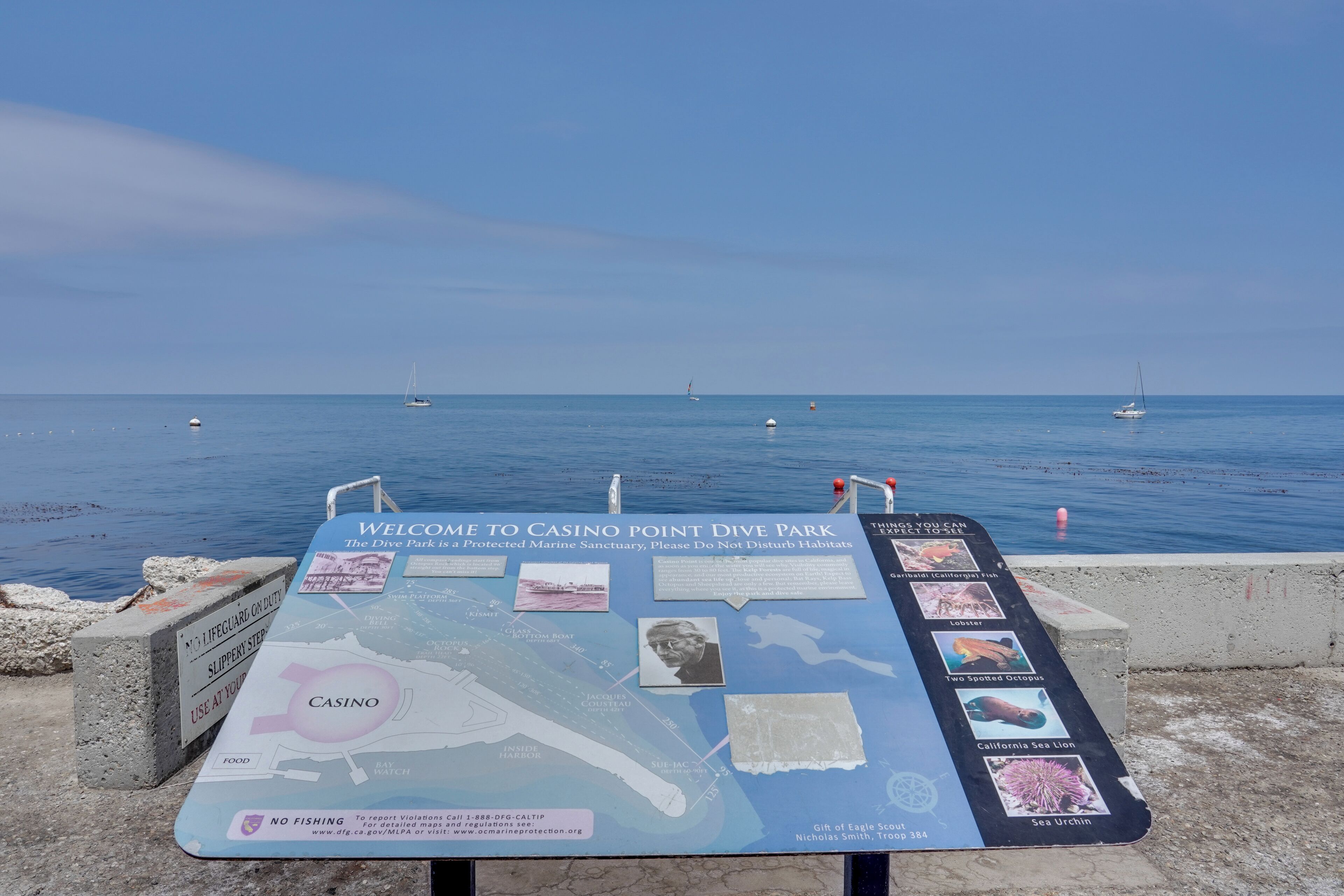 A welcome sign at Casino Point Dive Park with a map and information about marine life.