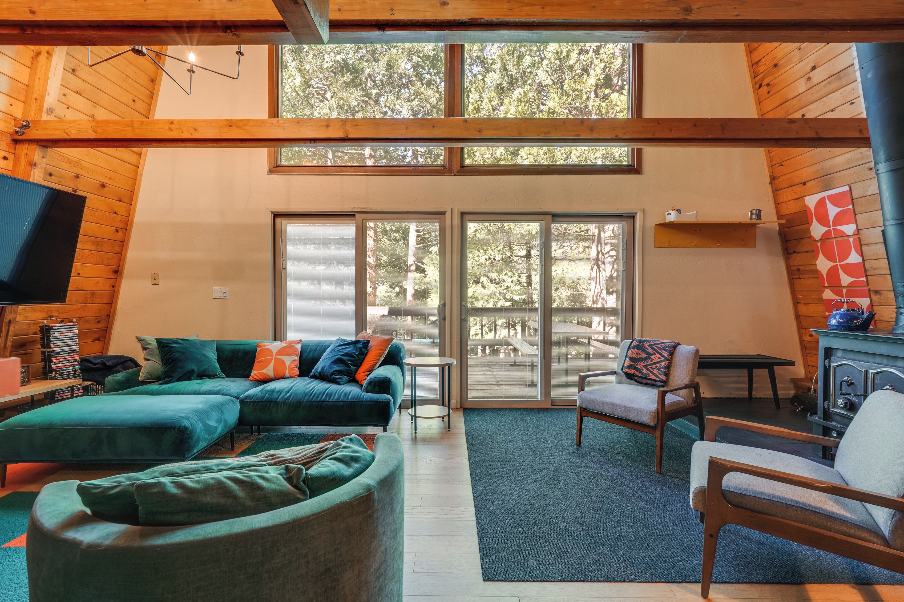 A cozy living room with a sectional sofa, a chair, a television, and a fireplace.