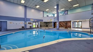 An indoor swimming pool with clear lane markings, a stone wall, and a staircase leading to an upper level. - Resort Amenities: Beech Mtn Condo Near Skiing! (Banner Elk)
