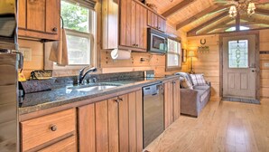 A wooden cabin kitchen with a built-in microwave, a sink, and a wooden countertop. - Near Winter Trails! Rustic Cabin in Mill Spring (Mill Spring)