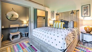 A bedroom with a bed, a mirror, a wardrobe, a small stool, and a colorful rug. - Cortland Abode: 1 Mi to Greek Peak Mountain Resort (Cortland)