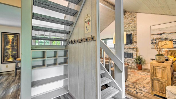 A staircase with a metal railing, a welcome sign, and a stone wall in the background. - Cortland Abode: 1 Mi to Greek Peak Mountain Resort (Cortland)