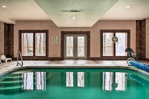 A swimming pool with a clear view of trees outside, a door with glass panels, and a chair by the pool. - Cosby Cabin w/ Hot Tub ~ 18 Mi to Gatlinburg! (Cosby)
