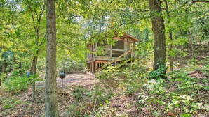 A rustic cabin with a wooden deck and a staircase leading to a porch. - Bright Davis Escape w/ Screened-in Porch! (Davis)