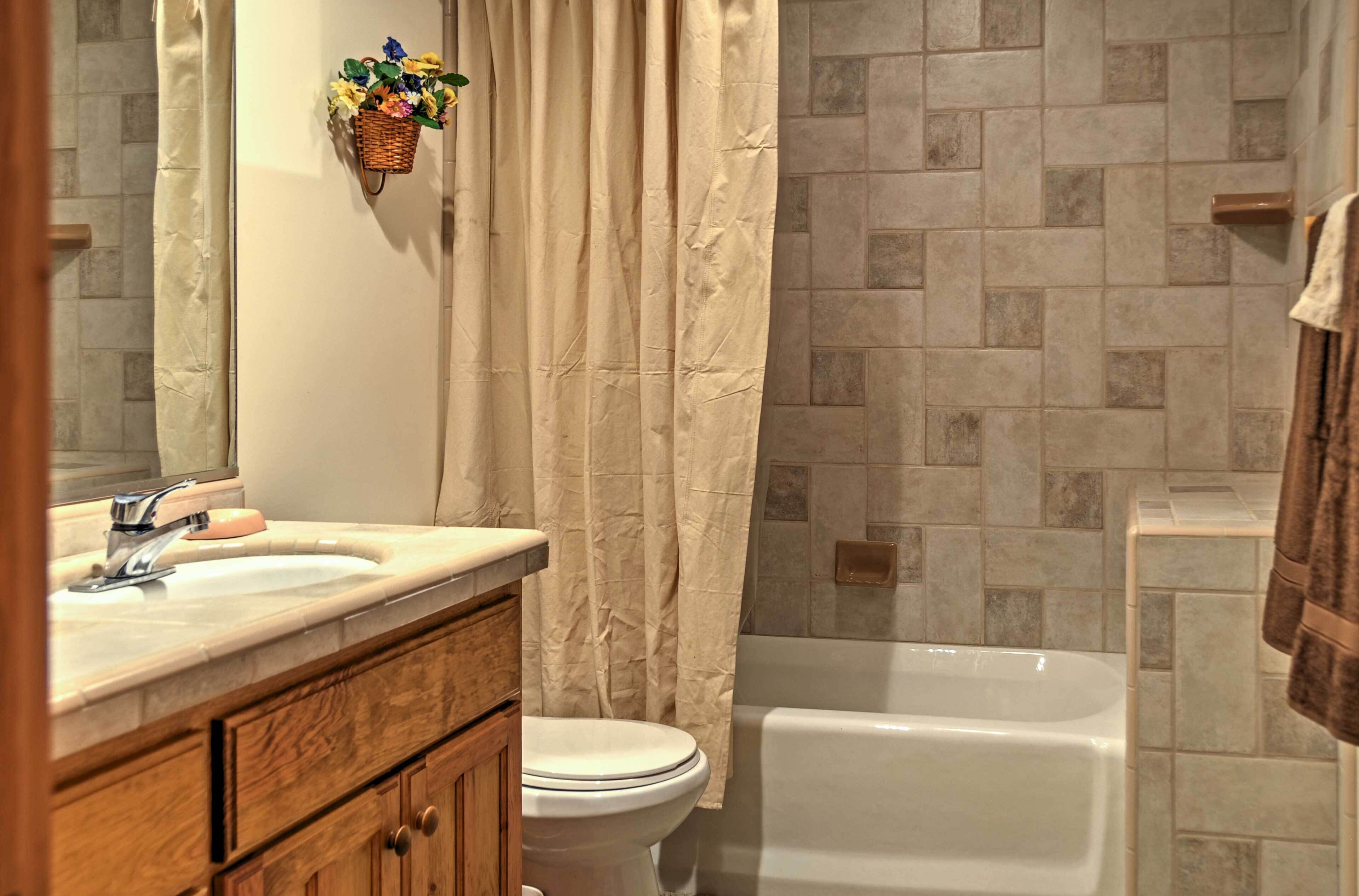 A bathroom with a sink, toilet, and bathtub.