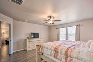 A bedroom with a bed, a dresser, a television, and a ceiling fan. - San Antonio Getaway w/ Game Room, Near Seaworld! (San Antonio)