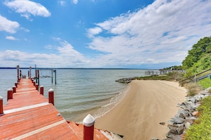 A wooden pier leading to a sandy beach with a clear sky. - Gloucester Retreat w/ Backyard Oasis & Pier! (Gloucester)