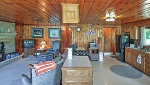 A cozy cabin interior with a living room, kitchen, and dining area. - 2 Mi to Boat Ramp! Family Cabin on Long Lake (Hale)