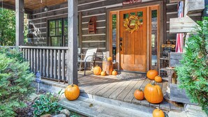A wooden cabin with a porch decorated with pumpkins and a welcome sign. - Hot Tub & Fire Pit: Getaway Near Nantahala Gorge! (Franklin)