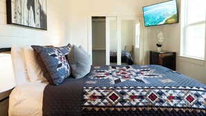 A bedroom with a large bed, a TV mounted on the wall, and a window. - Dog-friendly Texas Ranch w/ Patio, Horses On-site (Aubrey)