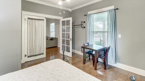 A bedroom with a bed, a desk with a chair, a ceiling fan, and a window with curtains. - Harrison Family Home w/ Grill - Near Downtown! (Harrison)